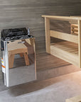 Harvia The Wall Sauna Heater Stainless Steel mounted on wall next to bench