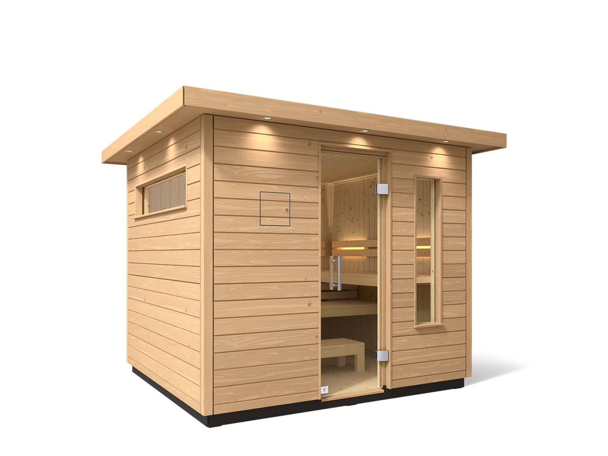 Kohler C2 sauna exterior with light wood angled with accent lighting on eaves and clear glass door