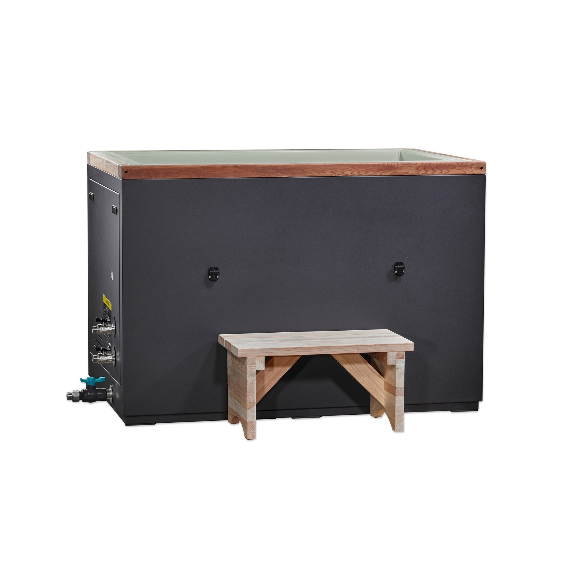 Green cuboid cold plunge tub seen from the front, cedar step alongside and fill valves visible