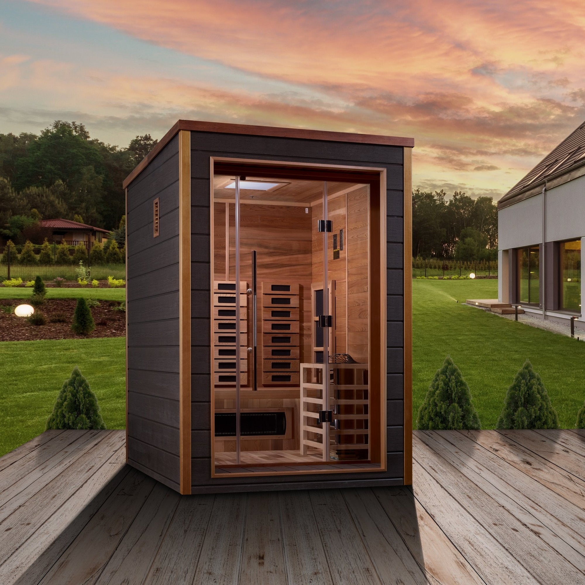Nora sauna sited beside a house in a garden setting
