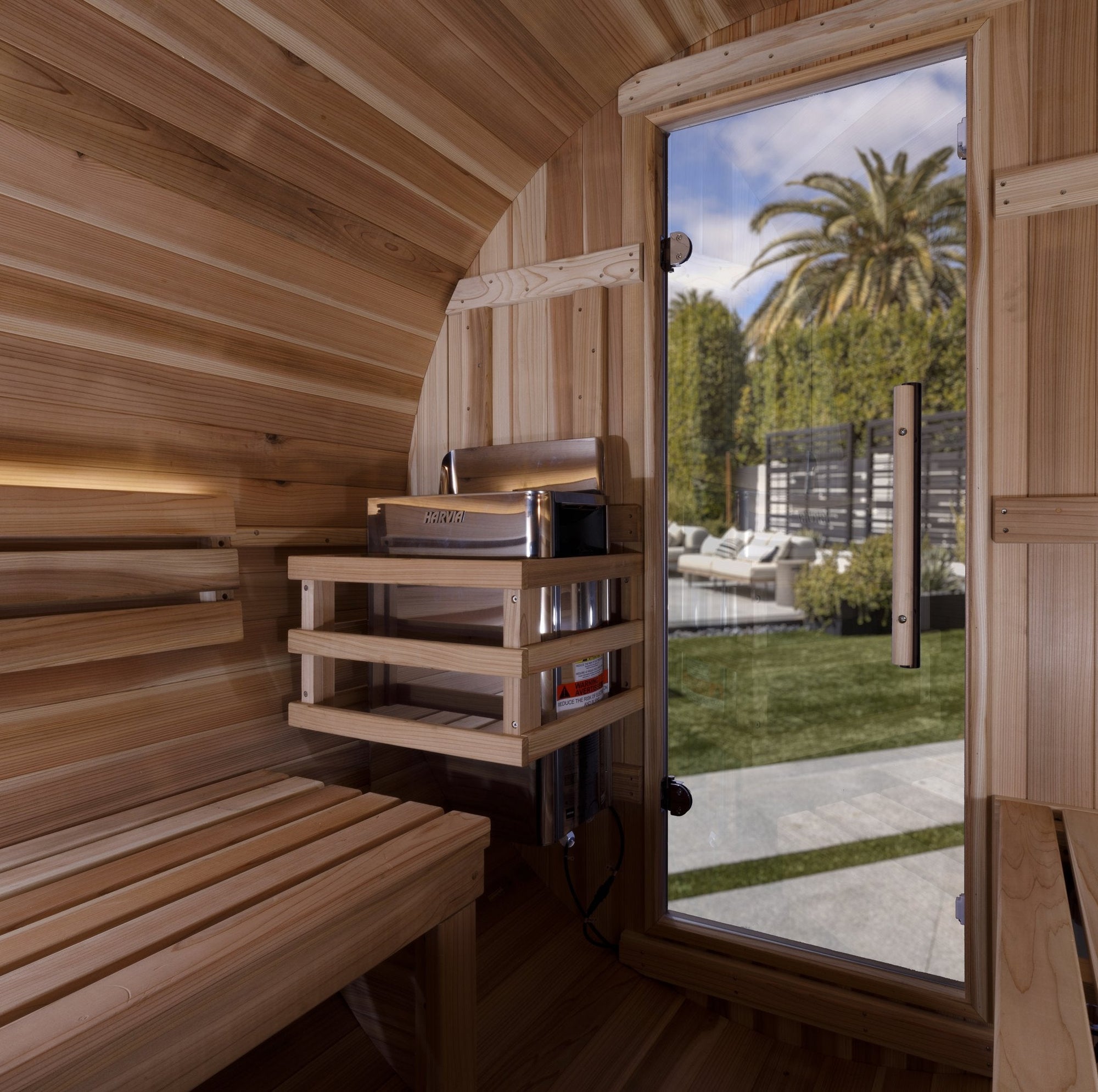 Zurich barrel sauna interior, facing benches and the stove