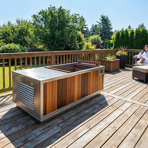 Outdoor hot tub or plunge tub on a wooden deck with trees in the background and a woman sitting on a bench nearby.