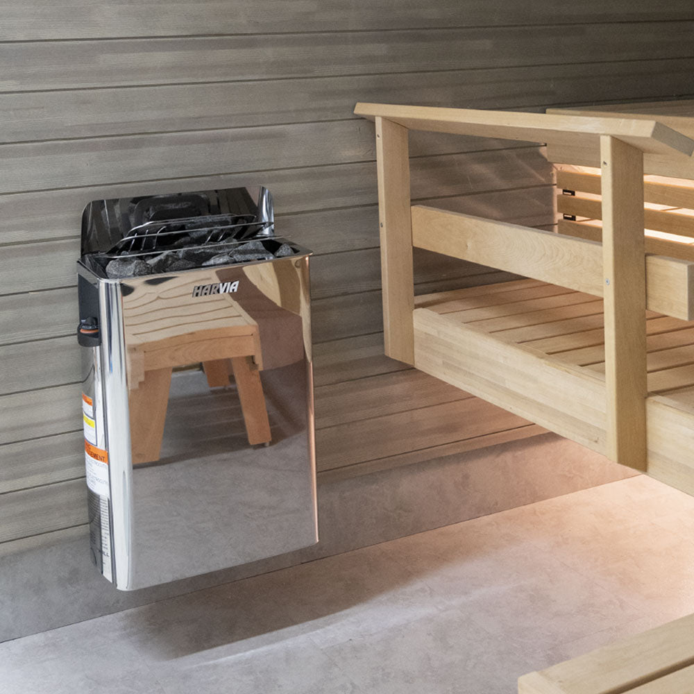 Harvia The Wall Sauna Heater Stainless Steel mounted on wall next to bench