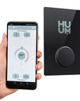 Smartphone displaying app interface next to a black device with 'HUUM' branding.