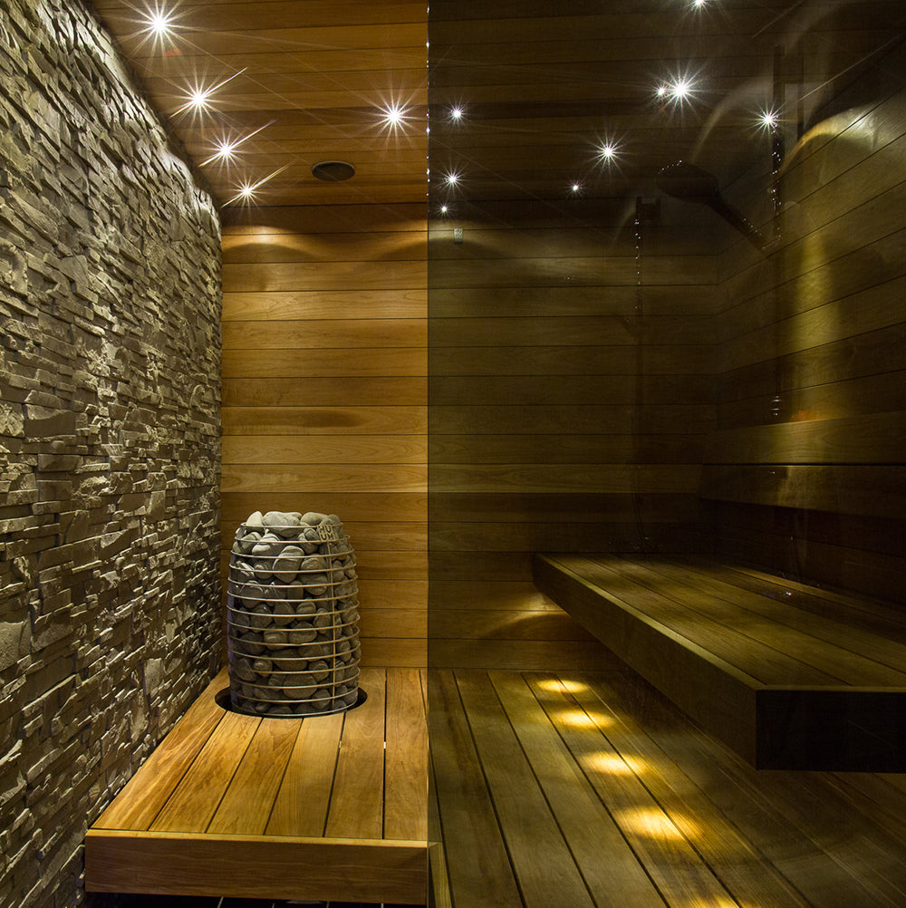 Wooden sauna with stone wall and bench