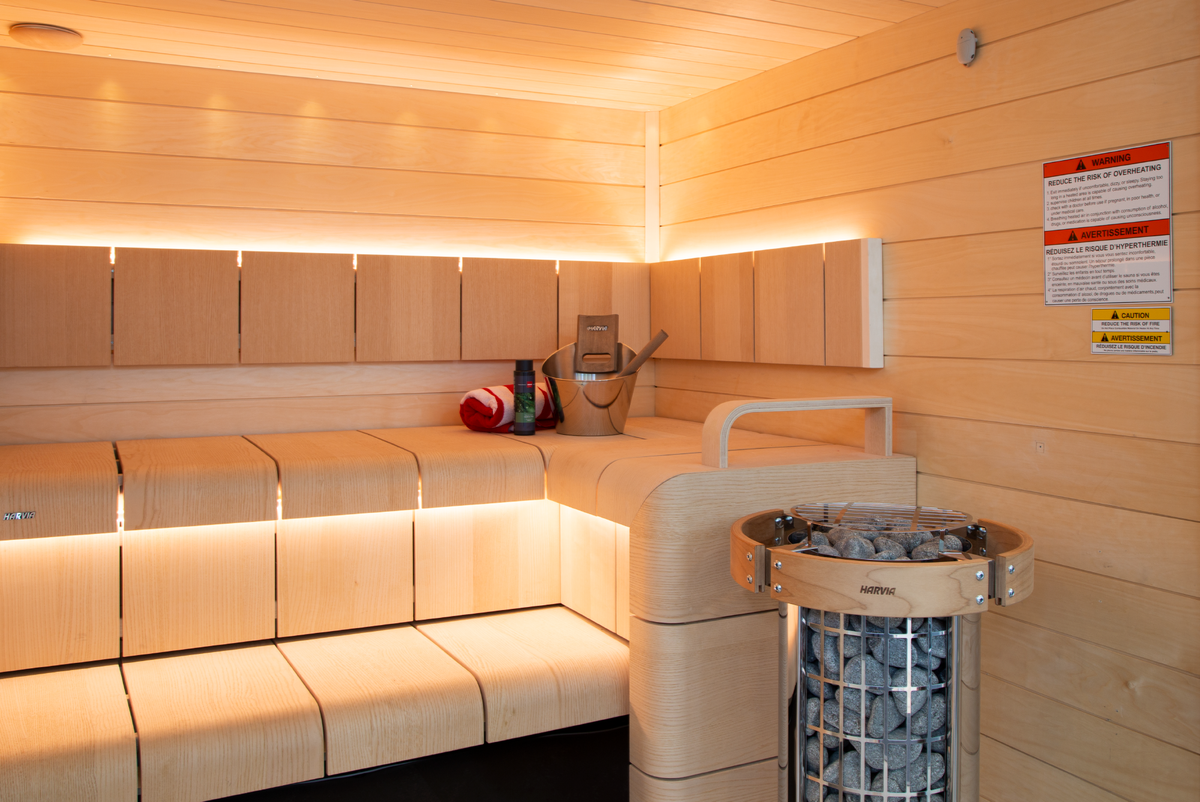 Harvia Cilindro Sauna Heater sauna interior with 2 bench levels and bucket with folded towel