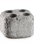 sauna steam stone with multiple holes on a white background