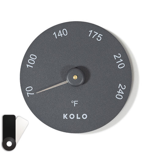 black aluminum circular sauna thermometer on a white background