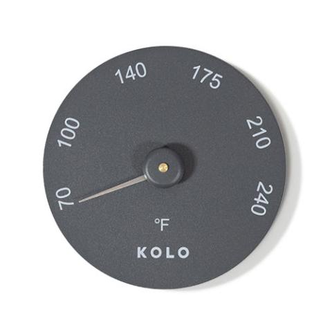 black aluminum circular sauna thermometer on a white background