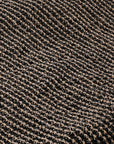 A close-up of a textured woven fabric with a diagonal ribbed pattern in dark brown and beige.