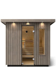 Kohler C2 Sauna Weathered Spruce exterior front view with indirect lighting on the eaves and a clear glass door