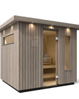 Kohler C2 Sauna Weathered Spruce exterior angled view with indirect lighting on the eaves and a clear glass door