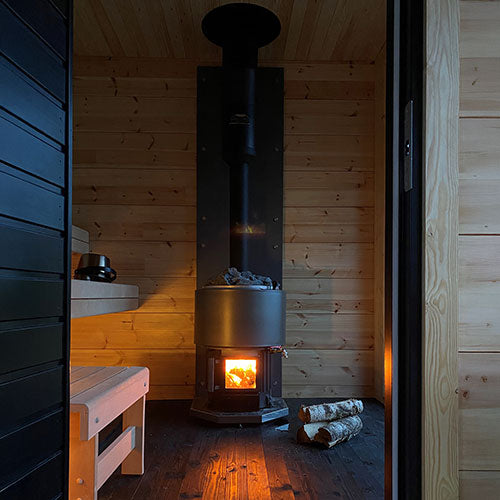 Narvi Luosto VS Sauna Stove view from entry of sauna with wood laying next to heater