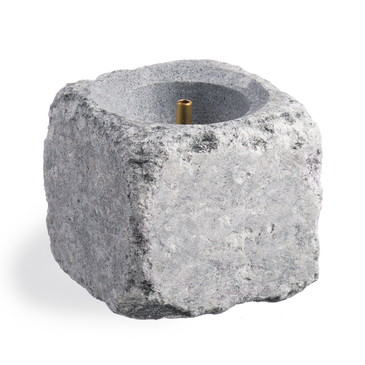 Decorative sauna stone with a brass center nozzle on a white background