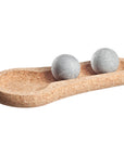 Cork tray with two grey sauna stones on a white background