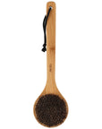 A bamboo-handled scrubber brush with dark brown bristles and a black hanging cord, shown on a plain white background.
