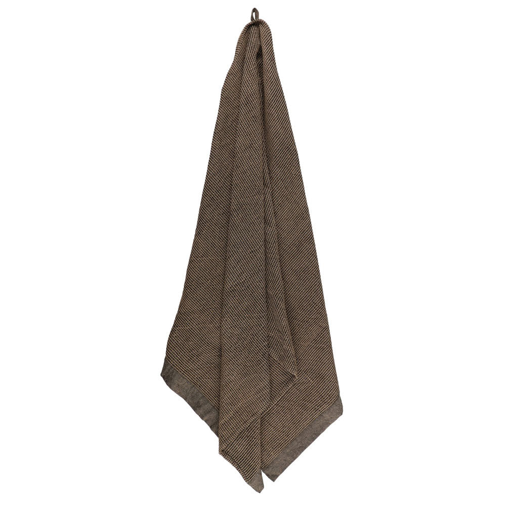 Brown textured towel hanging on a white background