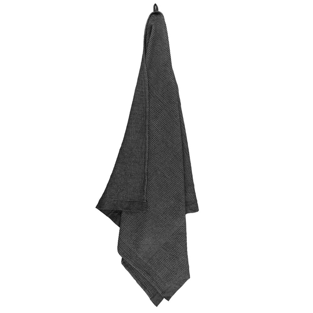 dark grey textured towel hanging on a white background