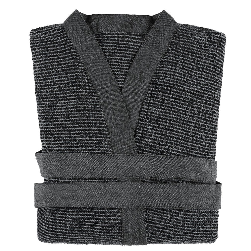 Folded dark gray sauna robe on a white background