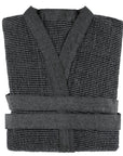 Folded dark gray sauna robe on a white background